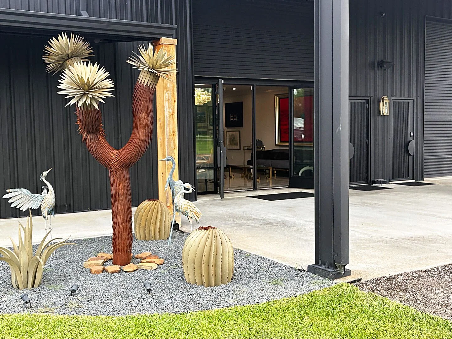 The courtyard entrance off County Road 125. If your appointment is in the Buying Room, park in the parking lot, follow the signs, and walk to the far left door, the main door of the Black House. If your appointment is in the Collector's Lounge, pull straight up in front of the showroom doors and stop on the concrete pad under the awning. We come out and greet you.